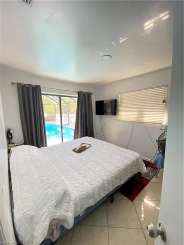 Tiled bedroom featuring access to outside