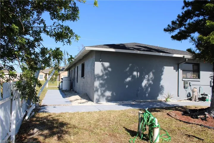 View of side of home featuring a yard