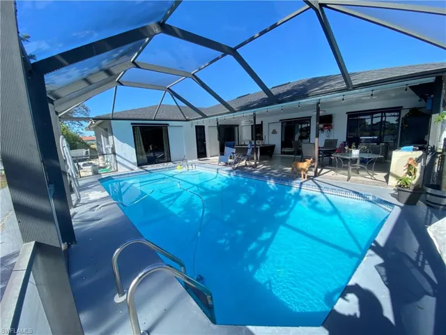 View of pool featuring ceiling fan, a patio area, and a lanai