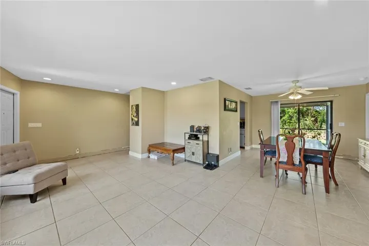 Tiled dining room featuring ceiling fan
