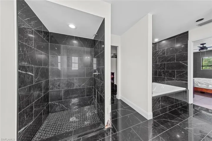 Bathroom with independent shower and bath and ceiling fan