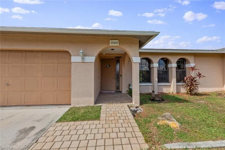 Doorway to property featuring a garage