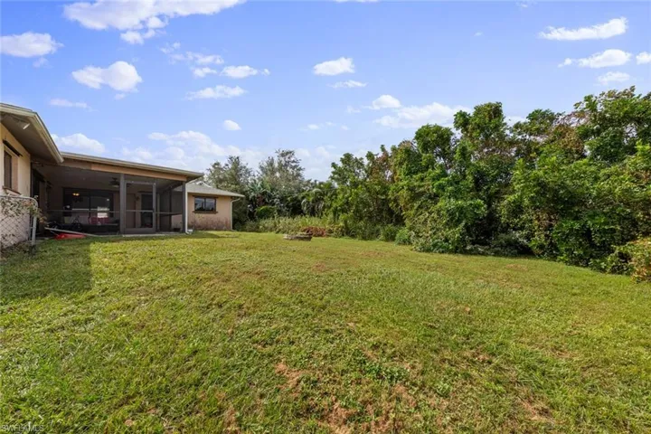 View of yard with a sunroom