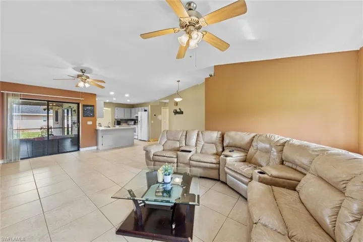 HUGE! multi family great room featuring ceiling fan, lofted ceiling, and light tile patterned floors