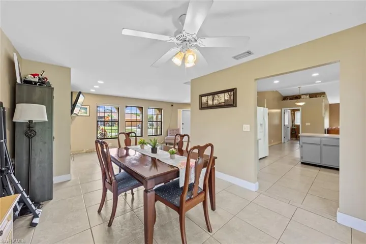 Foraml dinning area with light tile patterned flooring and ceiling fan