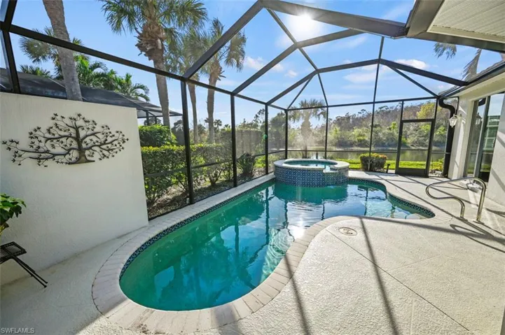Private heated pool and spa on a spacious lanai with beautiful west facing preserve and lake views!