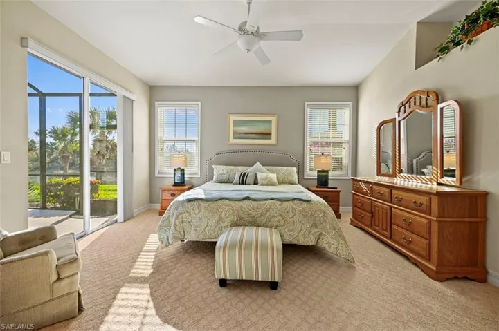 Lovely natural light pours into this primary bedroom with relaxing preserve and lake views!