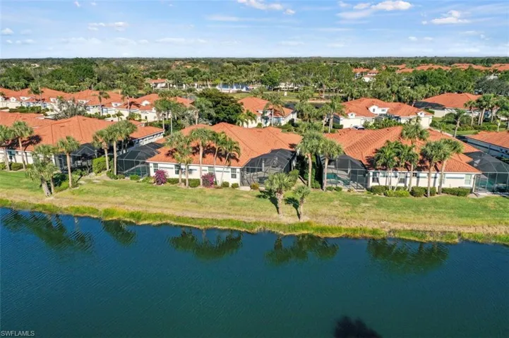 Rear aerial view of the lake and preserve behind the home