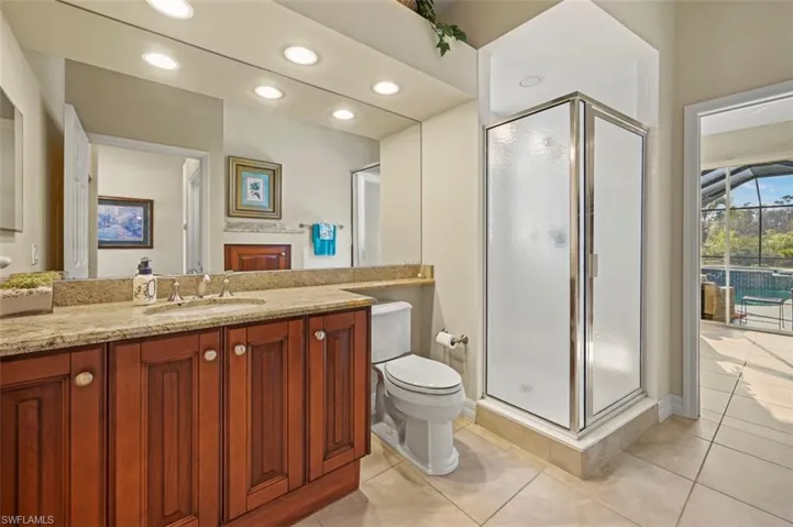 Guest bathroom with updated European cherry cabinets, granite counter tops, Kohler sink, faucet, and toilet.