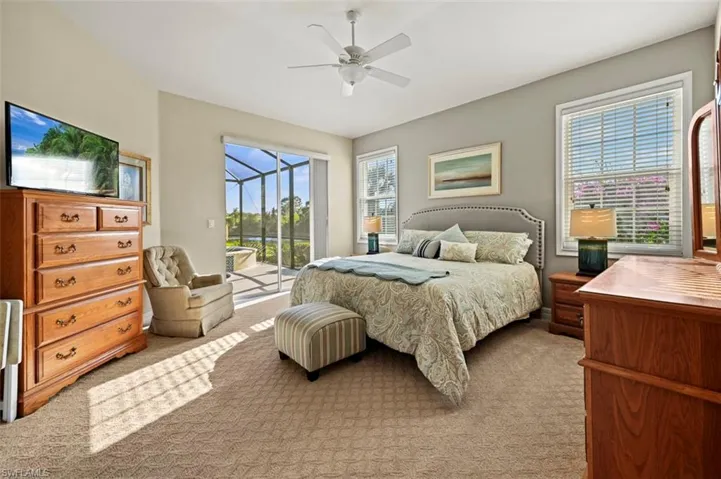 Large primary bedroom with lake and preserve views just outside your windows as well as private access to the lanai.