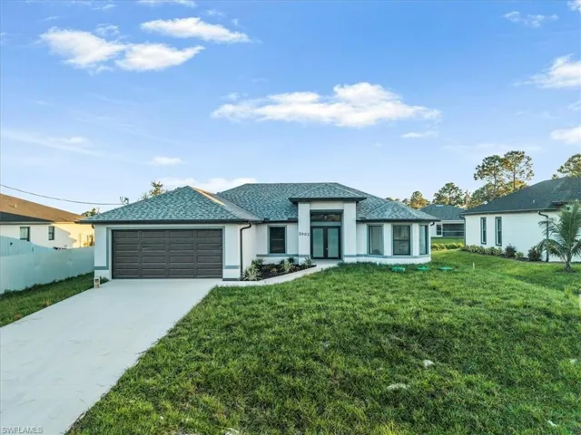 View of front of house with concrete driveway, an attached garage, stucco siding, and roof with shingles