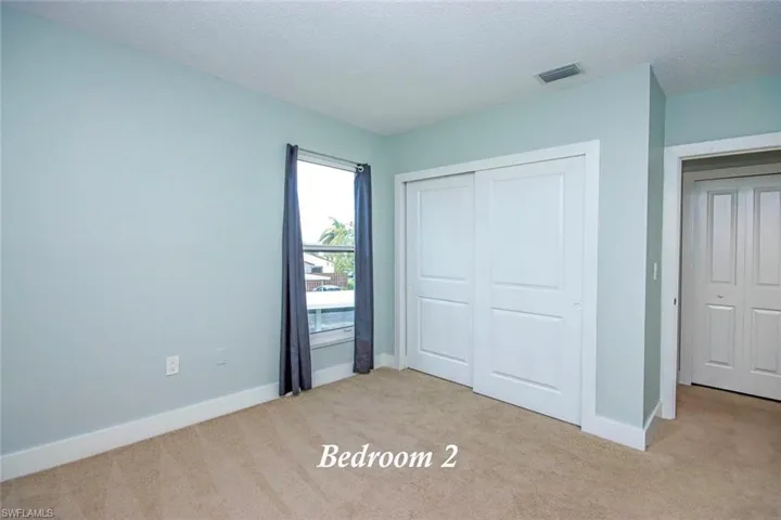 second floor guest bedroom with impact window
