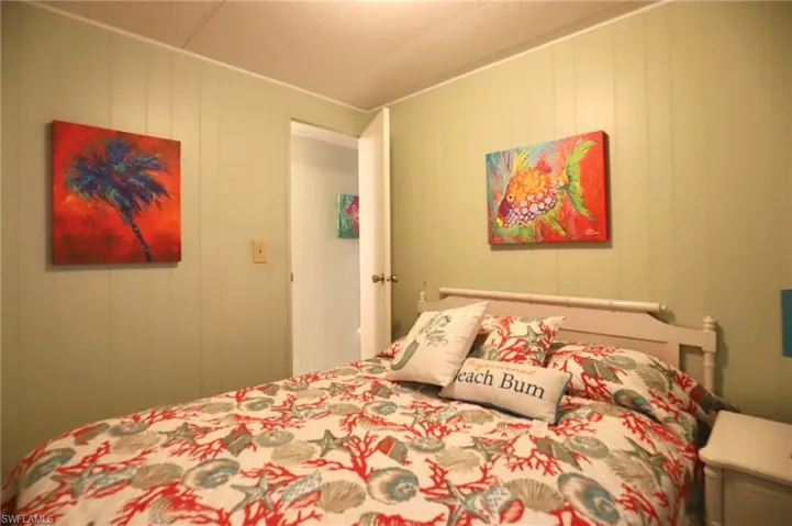 Bedroom featuring wood walls