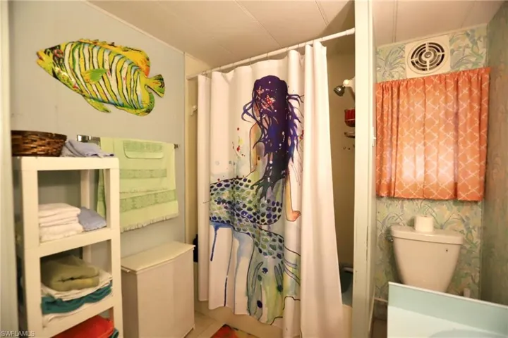 Bathroom with shower / tub combo and toilet