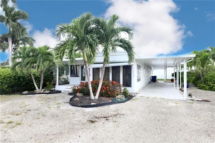 Rear view of property with a carport