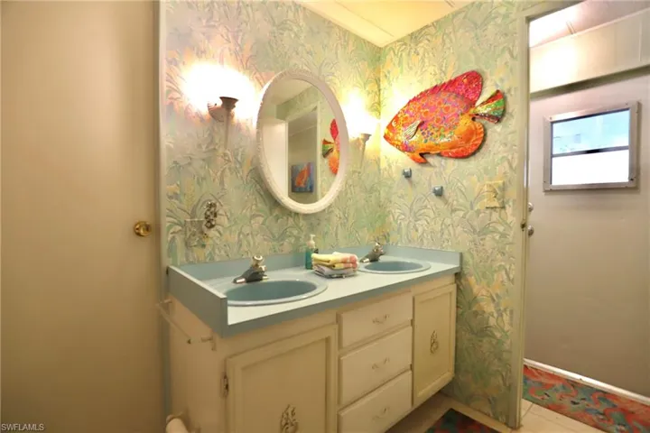 Bathroom with tile patterned floors and vanity