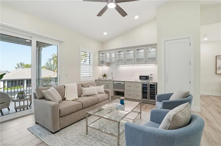 Wet bar, seating area, outdoor balcony overlooking waterfront