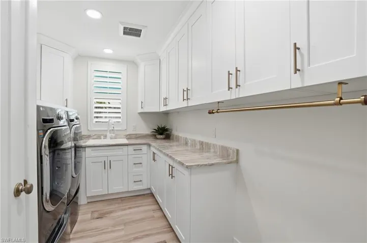 Laundry with built in custom cabinetry, laundry sink