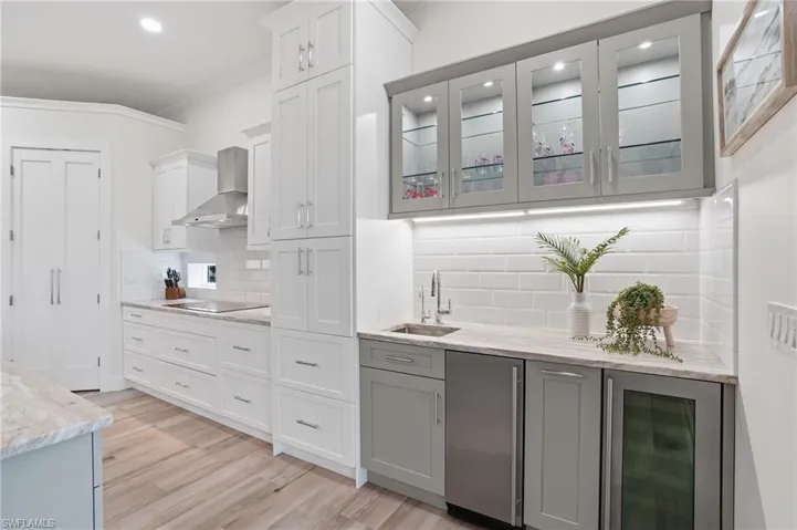 Gourmet kitchen with wet bar, undercounter ice maker, beverage center, cabinet ambient lighting
