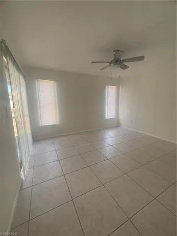 Spare room featuring a ceiling fan and light tile patterned floors