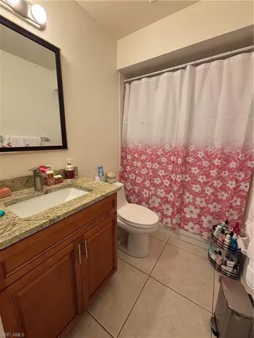 Full bathroom featuring vanity and light tile patterned floors