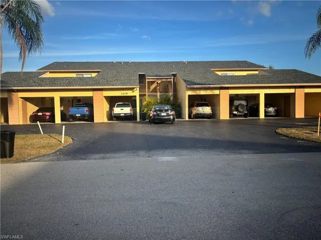 View of building exterior featuring driveway