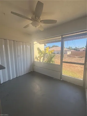 Unfurnished sunroom with a ceiling fan