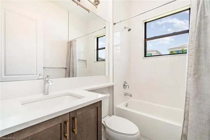 Bathroom with shower / bath combo and vanity