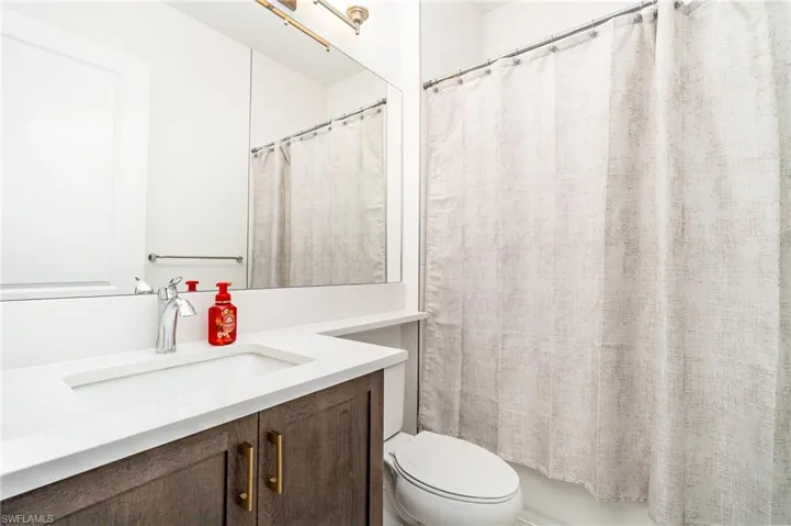 Full bath featuring vanity and shower / tub combo