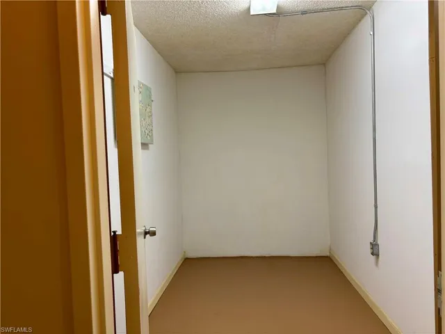 Spare room featuring concrete flooring and a textured ceiling