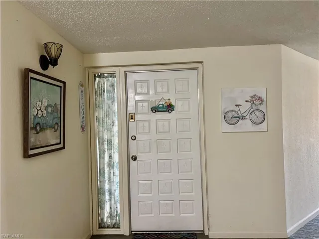 Entrance foyer with plenty of natural light and a textured ceiling