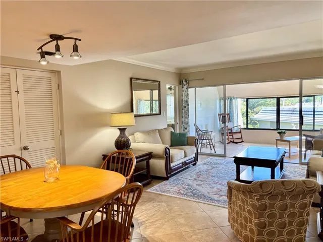 with light tile patterned flooring and ornamental molding