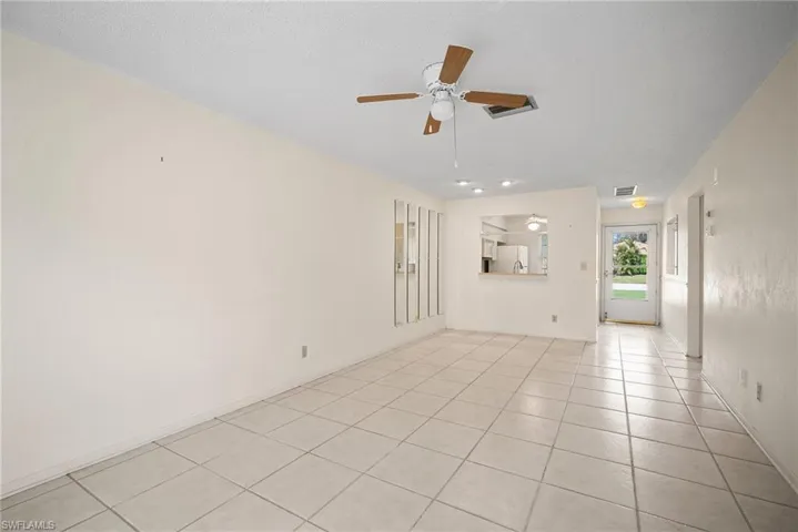 Spare room with light tile patterned flooring, a textured ceiling, and ceiling fan
