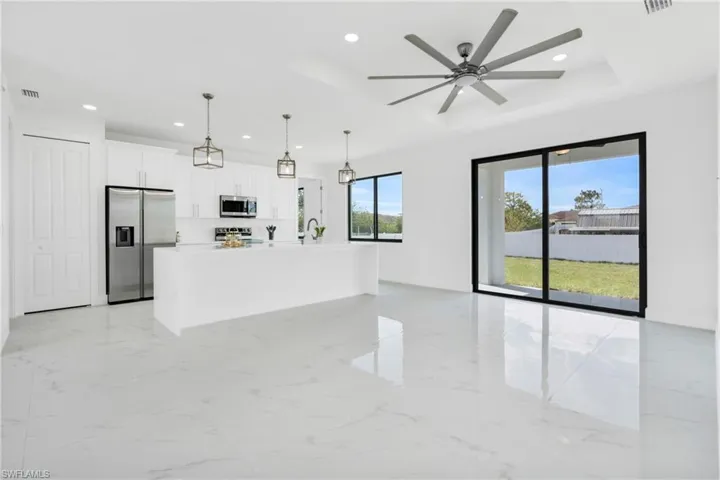 Unfurnished living room featuring recessed lighting, visible vents, a sink, and marble finish floor