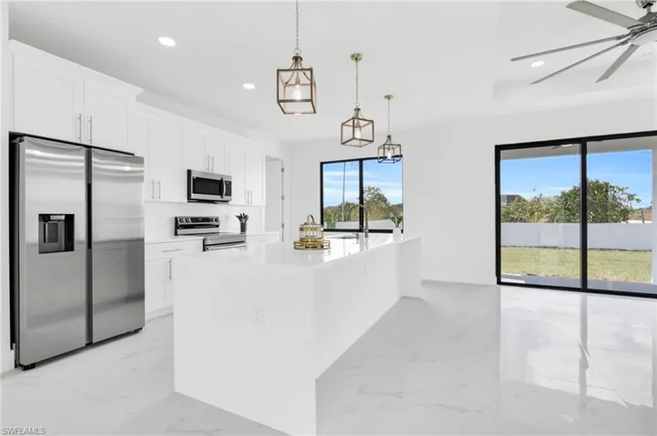 Kitchen with ceiling fan, appliances with stainless steel finishes, light countertops, marble finish floor, and recessed lighting