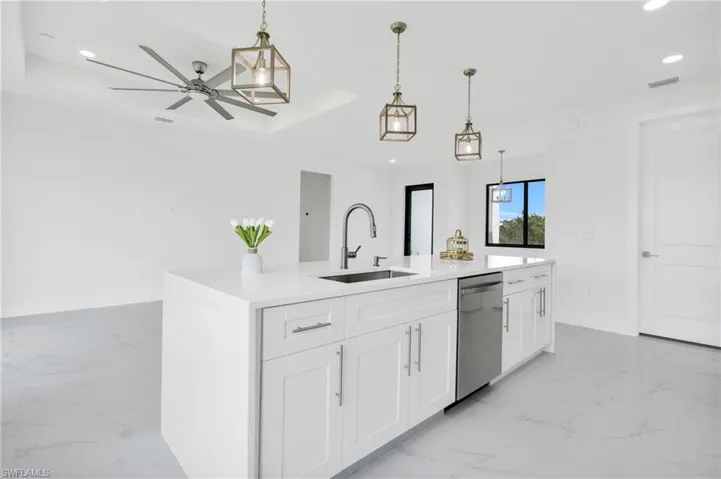 Kitchen with stainless steel dishwasher, recessed lighting, a sink, and marble finish floor