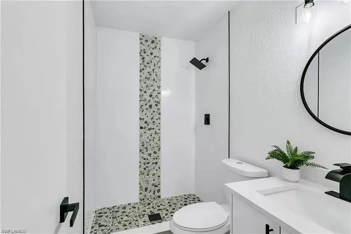 Bathroom featuring vanity and a shower stall