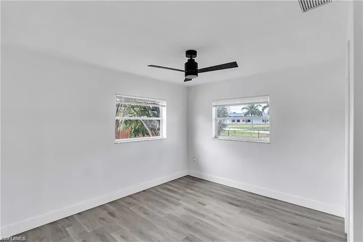 Empty room featuring light wood-type flooring and ceiling fan