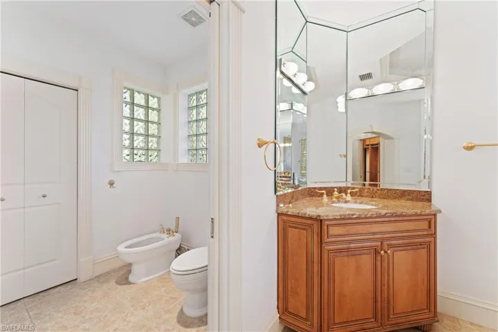 Bathroom featuring vanity, toilet, and a bidet