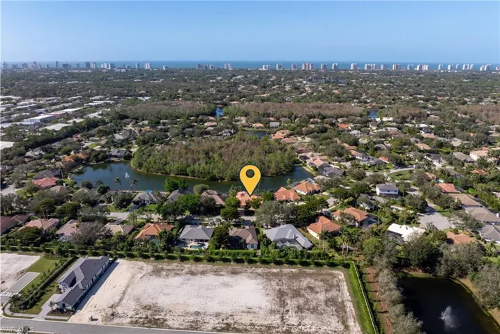 Birds eye view of property with a water view