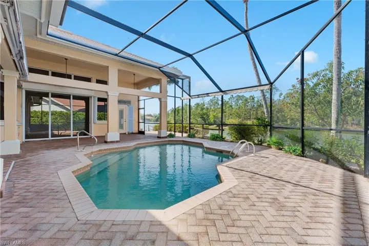 View of pool with ceiling fan, a lanai, and a patio