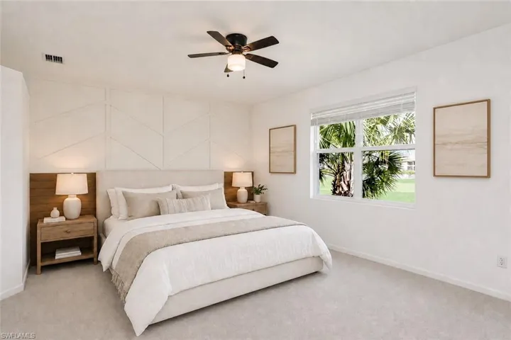 Geometric accent wall, ceiling fan, carpeted flooring, window with blinds, and white walls