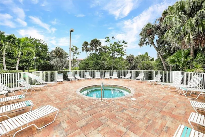 View of pool featuring a community hot tub and a patio