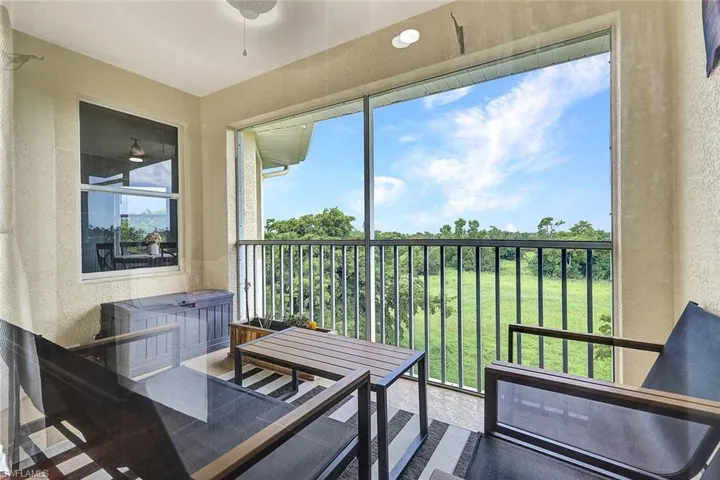 Sunroom / solarium with a wealth of natural light and ceiling fan
