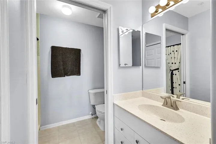 Bathroom with tile patterned floors, toilet, and vanity