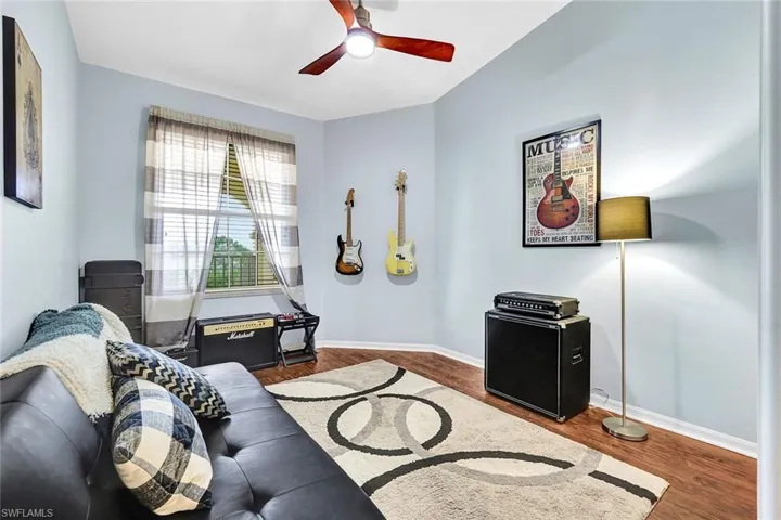 Living room with wood-type flooring and ceiling fan