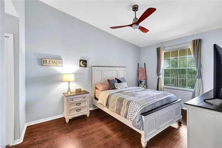 Bedroom with hardwood / wood-style floors and ceiling fan
