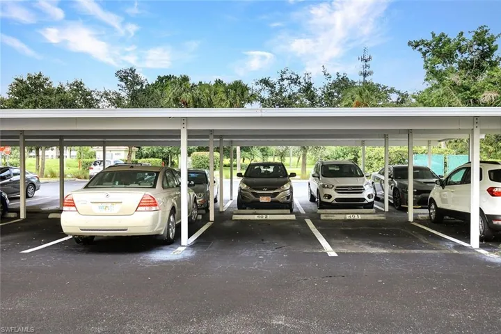 View of car parking featuring a carport