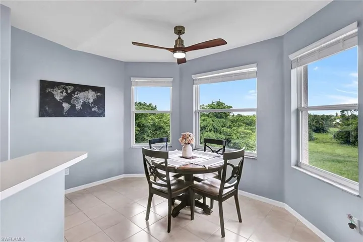 Tiled dining room with ceiling fan