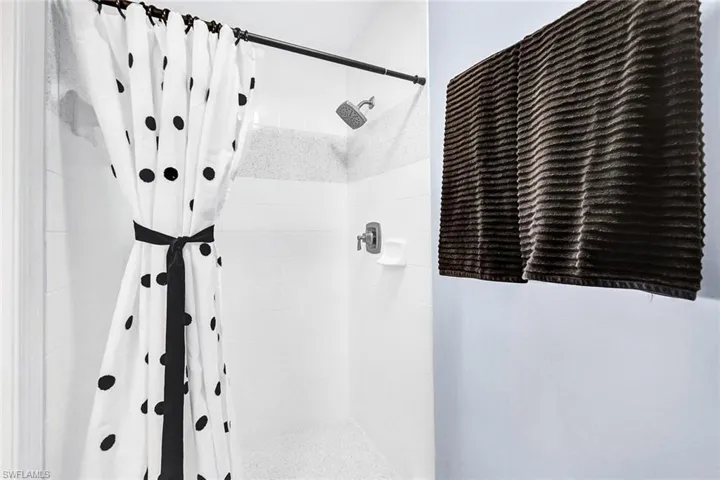 Bathroom featuring curtained shower